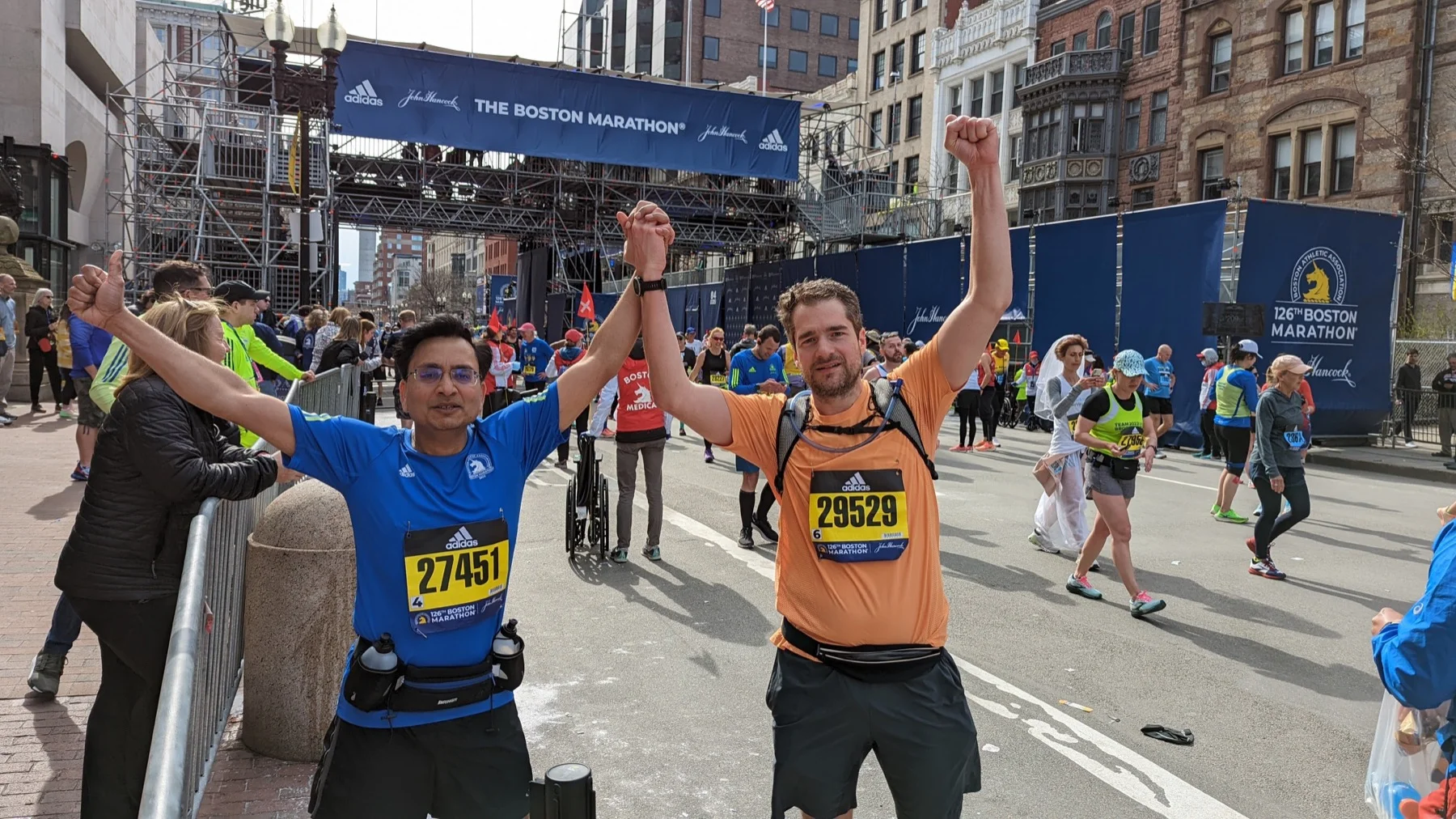 Ajay celebrating with another runner after the Boston Marathon in 2022